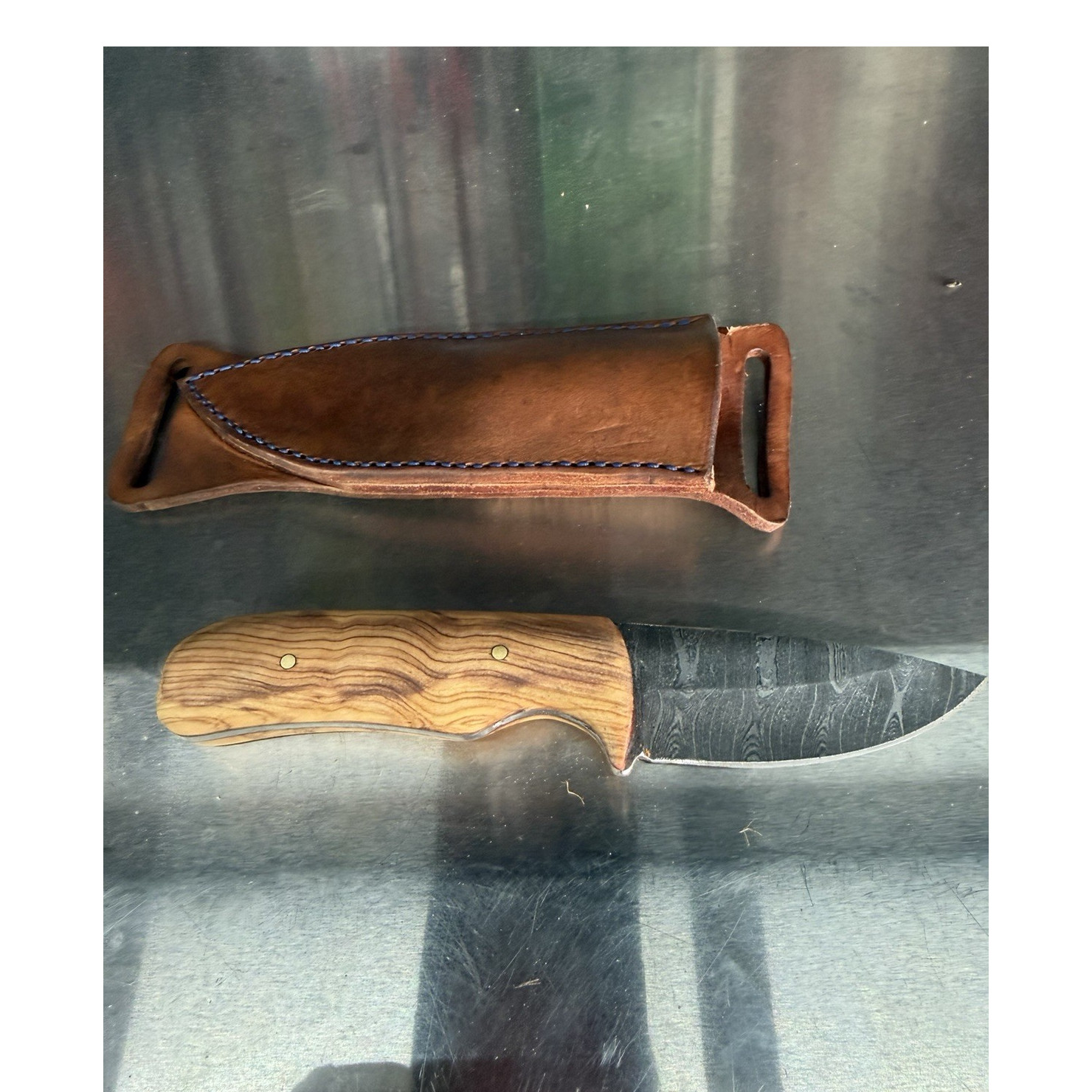 Made from Damascus and a maple handle, handmade knife one of a kind ￼
